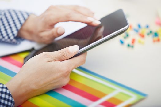 Hands of businessperson using digital tablet