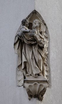 Saint Joseph holding baby Jesus, statue on the house facade in Graz, Styria, Austria