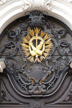 Franciscan monogram on the main entrance, Mariahilf church in Graz, Styria, Austria