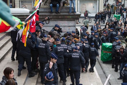 BELGIUM, Brussels: Police arrest at least ten people during a demonstration against racism at Bourse square on April 2, 2016, central Brussels, according to Belgian newspaper Le Soir. Belgian authorities ban any gathering on the same day. A week before, riot police fired water cannon at far-right football hooligans who invaded the same square in the Belgian capital that has become a memorial to the victims of the Brussels attacks. 