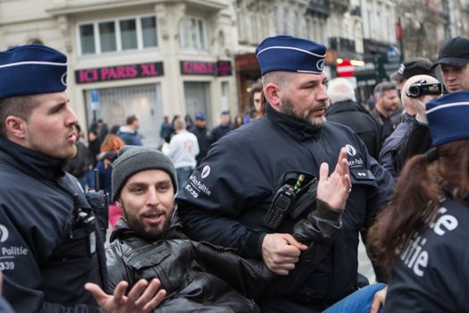 BELGIUM, Brussels: Police arrest at least ten people during a demonstration against racism at Bourse square on April 2, 2016, central Brussels, according to Belgian newspaper Le Soir. Belgian authorities ban any gathering on the same day. A week before, riot police fired water cannon at far-right football hooligans who invaded the same square in the Belgian capital that has become a memorial to the victims of the Brussels attacks. 