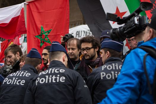 BELGIUM, Brussels: Police arrest at least ten people during a demonstration against racism at Bourse square on April 2, 2016, central Brussels, according to Belgian newspaper Le Soir. Belgian authorities ban any gathering on the same day. A week before, riot police fired water cannon at far-right football hooligans who invaded the same square in the Belgian capital that has become a memorial to the victims of the Brussels attacks. 