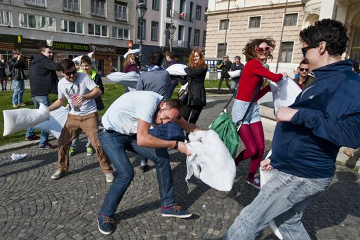 SLOVAKIA, Bratislava: Feathers fall on participants of a public pillow fight in Hviezdoslavovo námestie square, central Bratislava, on April 2, 2016.