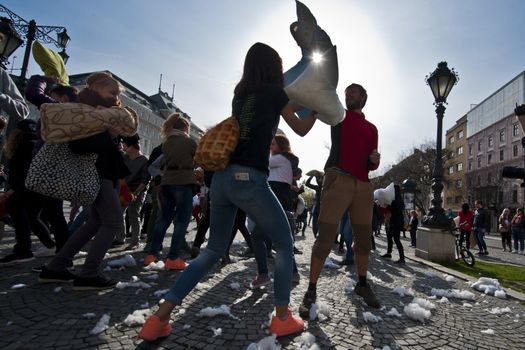 SLOVAKIA, Bratislava: Feathers fall on participants of a public pillow fight in Hviezdoslavovo námestie square, central Bratislava, on April 2, 2016.