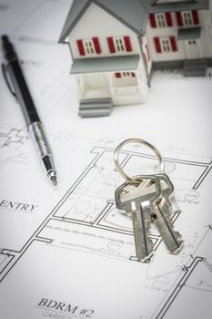 Model Home, Pencil and Keys Resting On Custom House Plans.