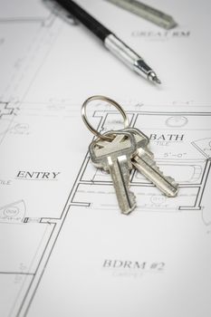 Engineer Pencil, Ruler and Keys Resting On Custom House Plans.