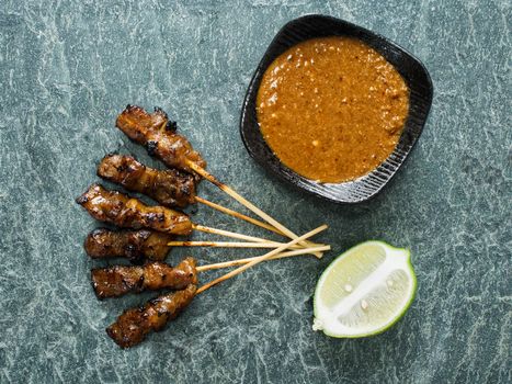 close up of rustic indonesian satay meat skewer