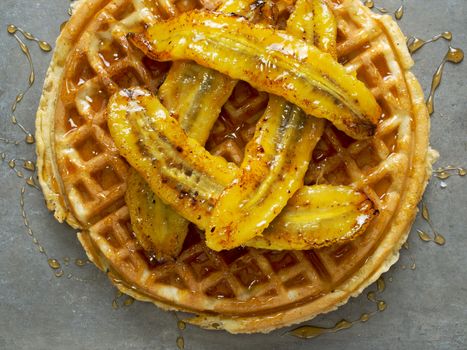 close up of rustic sweet banana waffle with syrup