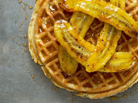 close up of rustic sweet banana waffle with syrup