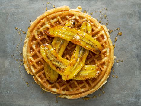 close up of rustic sweet banana waffle with syrup