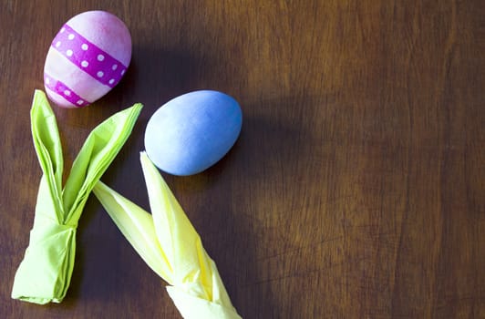 Easter holidays. Colorful Easter eggs and rabbits ears from paper napkins