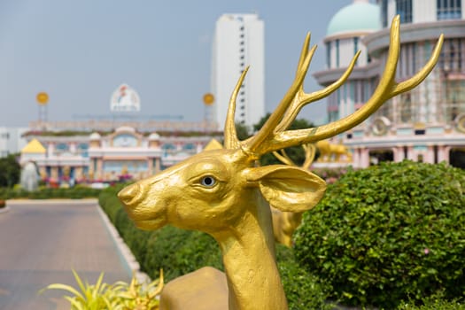 statue of a golden deer in the park