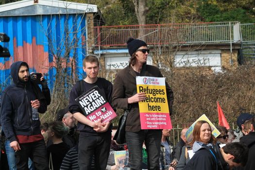 UNITED KINGDOM, Dover: Anti-racism demonstrators chant slogans and hold placards reading Refugees welcome here as they block the route of a planned far right march in Dover, southern England, on April 2, 2016. The march, which began shortly after 1pm, was disrupted as anti-fascist protesters refused to assemble in a designated area near Marine Parade, leading to eight arrests. Police arrested 13 people in total in Dover the same day as far-right and anti-fascist groups both held protests.