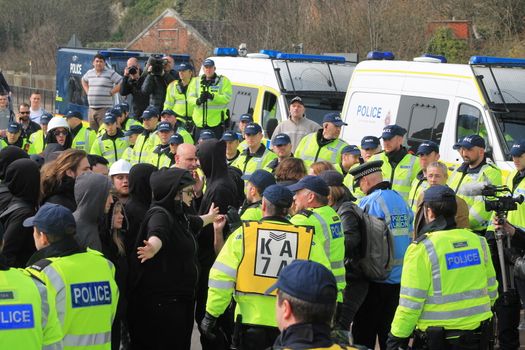 UNITED KINGDOM, Dover: Police try to clear the road of anti-racism demonstrators attempting to block the route of a planned far right march through Dover, southern England, on April 2, 2016.The march, which began shortly after 1pm, was disrupted as anti-fascist protesters refused to assemble in a designated area near Marine Parade, leading to eight arrests. Police arrested 13 people in total in Dover the same day as far-right and anti-fascist groups both held protests.