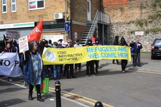 UNITED KINGDOM, Dover: Anti-racism demonstrators chant slogans and hold placards as they block the route of a planned far right march in Dover, southern England, on April 2, 2016. The march, which began shortly after 1pm, was disrupted as anti-fascist protesters refused to assemble in a designated area near Marine Parade, leading to eight arrests. Police arrested 13 people in total in Dover the same day as far-right and anti-fascist groups both held protests.