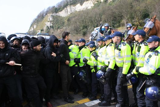 UNITED KINGDOM, Dover: Police try to clear the road of anti-racism demonstrators attempting to block the route of a planned far right march through Dover, southern England, on April 2, 2016.The march, which began shortly after 1pm, was disrupted as anti-fascist protesters refused to assemble in a designated area near Marine Parade, leading to eight arrests. Police arrested 13 people in total in Dover the same day as far-right and anti-fascist groups both held protests.