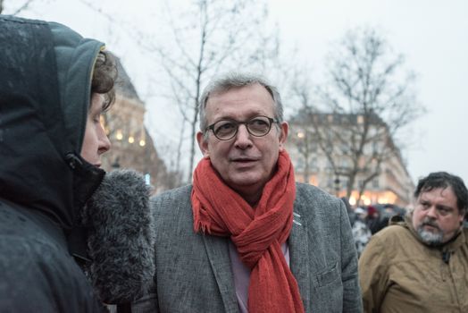 FRANCE, Paris : French Communist Party (PCF) General Secretary and Party of the European Left (EL) president Pierre Laurent (R) speaks to French Europe Ecologie Les Verts (EELV) green party spokesman Julien Bayou (L) as people join the Nuit Debout or Standing night movement at the Place de la Republique in Paris on April 2, 2016. A few hundred people rallied to demand the halt of home evictions which can begin the day after the end of the French winter break, after which tenants can be evicted from their homes. They also gathered to show their opposition to the labor reform law in the wake of the nationwide demonstration which took place on March 31, 2016.