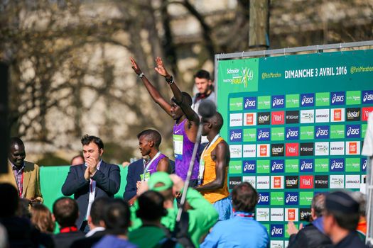 FRANCE, Paris: Kenyan Cyprian Kotut poses and raises his arms on the podium during the 40th Paris Marathon, on April 3, 2016 in Paris. Kenya's Cyprian Kotut won men race of 40th edition of the Paris marathon, adding to his victory in the half-marathon here less than a month ago. Some 57,000 participants from 160 countries have registered with the race covering 42,195km starting on the Champs Elysees and crossing the French capital to the Bois de Vincennes on the east.