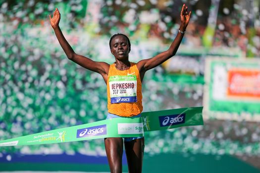 FRANCE, Paris: Kenyan Visiline Jepkesho passes the finish line during the 40th Paris Marathon, on April 3, 2016 in Paris. Kenya's Visiline Jepkesho won women race of 40th edition of the Paris marathon. Some 57,000 participants from 160 countries have registered with the race covering 42,195km starting on the Champs Elysees and crossing the French capital to the Bois de Vincennes on the east.