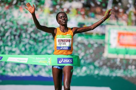 FRANCE, Paris: Kenyan Visiline Jepkesho passes the finish line during the 40th Paris Marathon, on April 3, 2016 in Paris. Kenya's Visiline Jepkesho won women race of 40th edition of the Paris marathon. Some 57,000 participants from 160 countries have registered with the race covering 42,195km starting on the Champs Elysees and crossing the French capital to the Bois de Vincennes on the east.