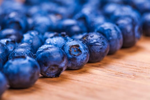 natural fresh blueberries closeup on wooden background