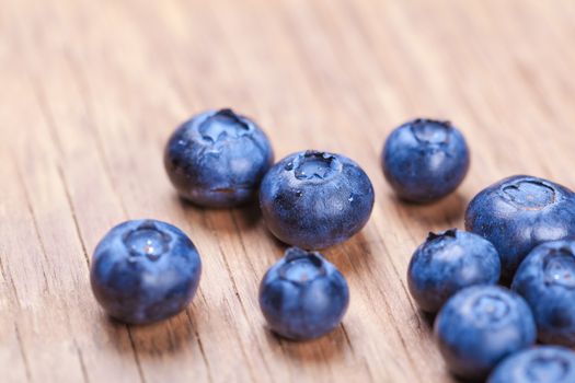natural fresh blueberries closeup on wooden background