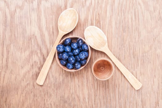 natural fresh blueberries closeup on wooden background