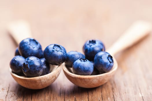 natural fresh blueberries closeup on wooden background