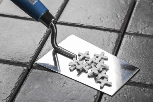 the trowel closeup on a background of ceramic tile
