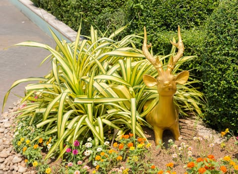 Sculpture of small golden deer grass looking out