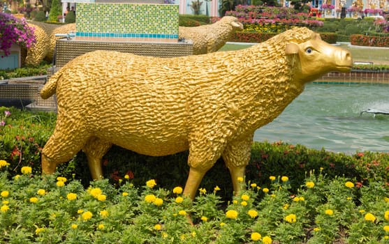 Sculpture of golden sheep in the park
