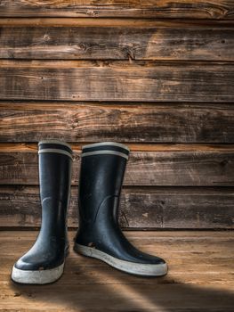 Rubber Boots Or Wellingtons On The Porch Of A Farmhouse Or Homestead