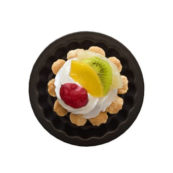 Cake basket with cream and slices of fruit isolated on a white background.