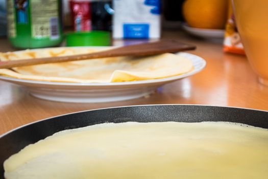 Pancake baked on frying pan in the kitchen