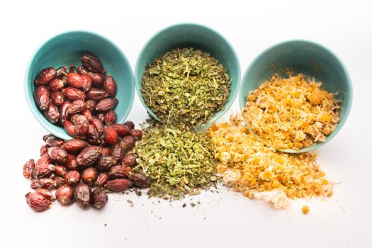 Spilled tea herb in bowls on white background