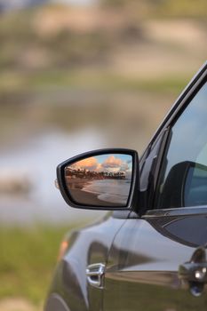 Sunset over Laguna Beach in the rear view mirror of a car in Southern California