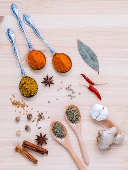 Assorted of dried spices white pepper,cumin ,bay leaf,cinnamon,star anise,thyme,ginger ,chili ,garlic  and rosemary on wooden background.