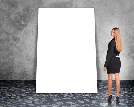 Big blank banner with businesswoman in suit on grey wall background