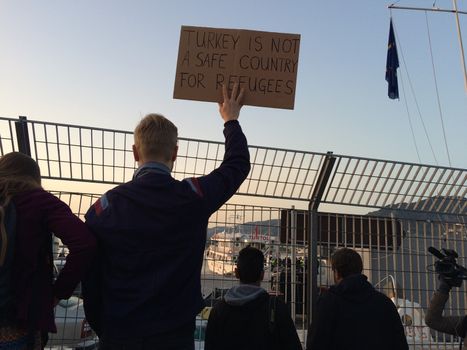 GREECE, Lesvos: A man holds a sign reading Turkey is not a safe country for refugees in Lesbos, Greece on April 4, 2016 as Greece sent a first wave of migrants back to Turkey under an EU deal that has faced heavy criticism from rights groups. Under the agreement, designed to halt the main influx which comes from Turkey, all irregular migrants arriving since March 20 face being sent back, although the deal calls for each case to be examined individually. For every Syrian refugee returned, another Syrian refugee will be resettled from Turkey to the EU, with numbers capped at 72,000.