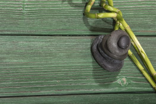 spa bamboo on green wooden background