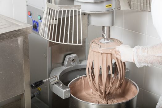 chef is preparing cake mix in industrial bread mixer- kneading machine