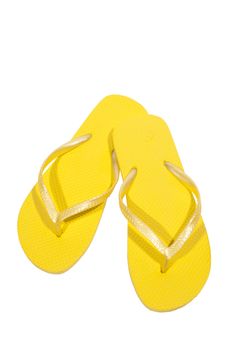 Vertical shot of yellow flip flops or thongs.  Isolated on white.