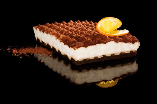 Delicious tiramisu dessert isolated on black background. Traditional sweet dessert.