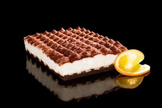 Delicious tiramisu dessert isolated on black background. Traditional sweet dessert.