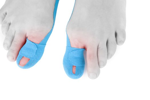 Therapeutic tape on female toe isolated on white background. Chronic pain, alternative medicine. Rehabilitation and physiotherapy.