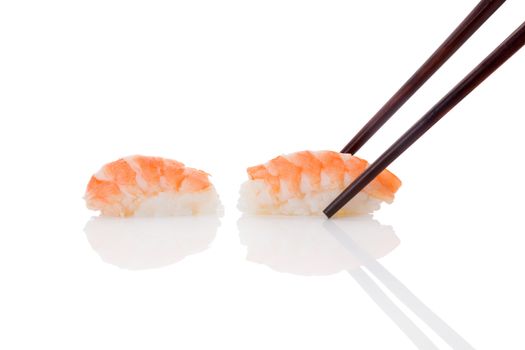 Delicious luxurious nigiri sushi with shrimp and chopsticks isolated on white background. Minimal contemporary asian style.