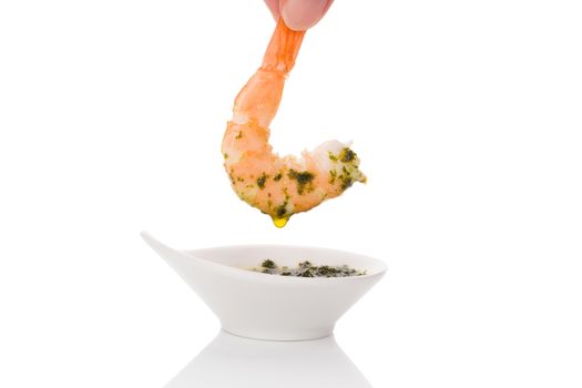 Delicious shrimp eating. Dripping cooked prawn into delicious sauce. Culinary and gourmet eating. 