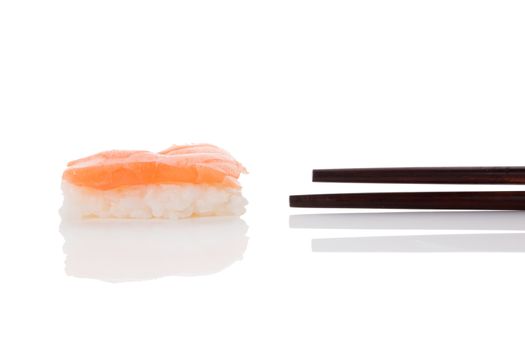 Delicious luxurious nigiri sushi with salmon and chopsticks isolated on white background. Minimal contemporary asian style.
