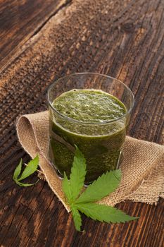 Healthy cannabis smoothie on wooden background. Natural supplement, detox and healthy living. 