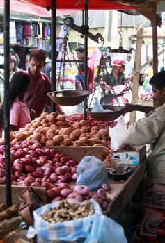 Colombo, Sri Lanka - April 9, 2011: Sri Lankan people on the fruit market in the Pettah district. The Pettah neighborhood is famous for its open air bazaars and markets